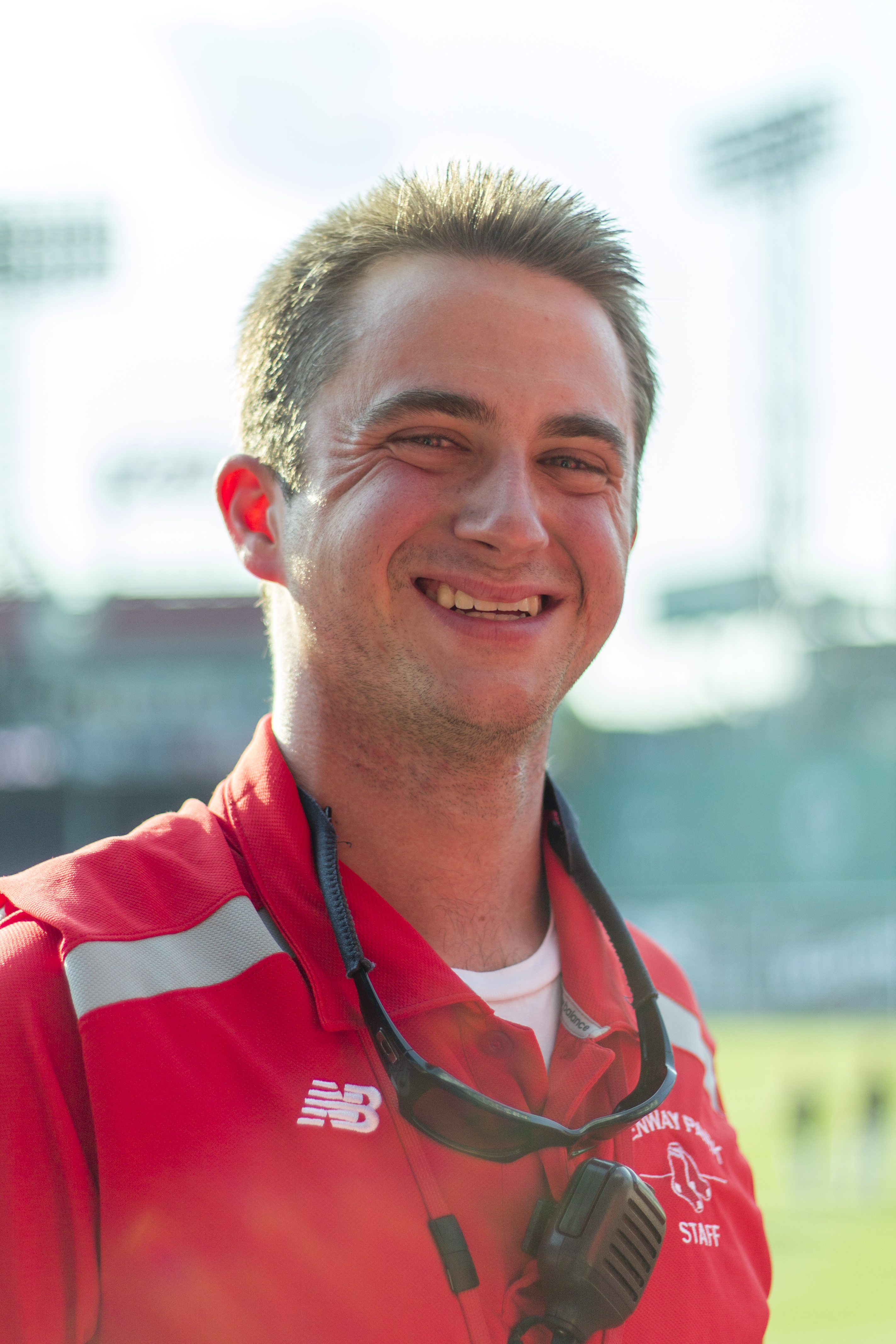 A white man wearing a Red Sox usher uniform smiles at the camera.
