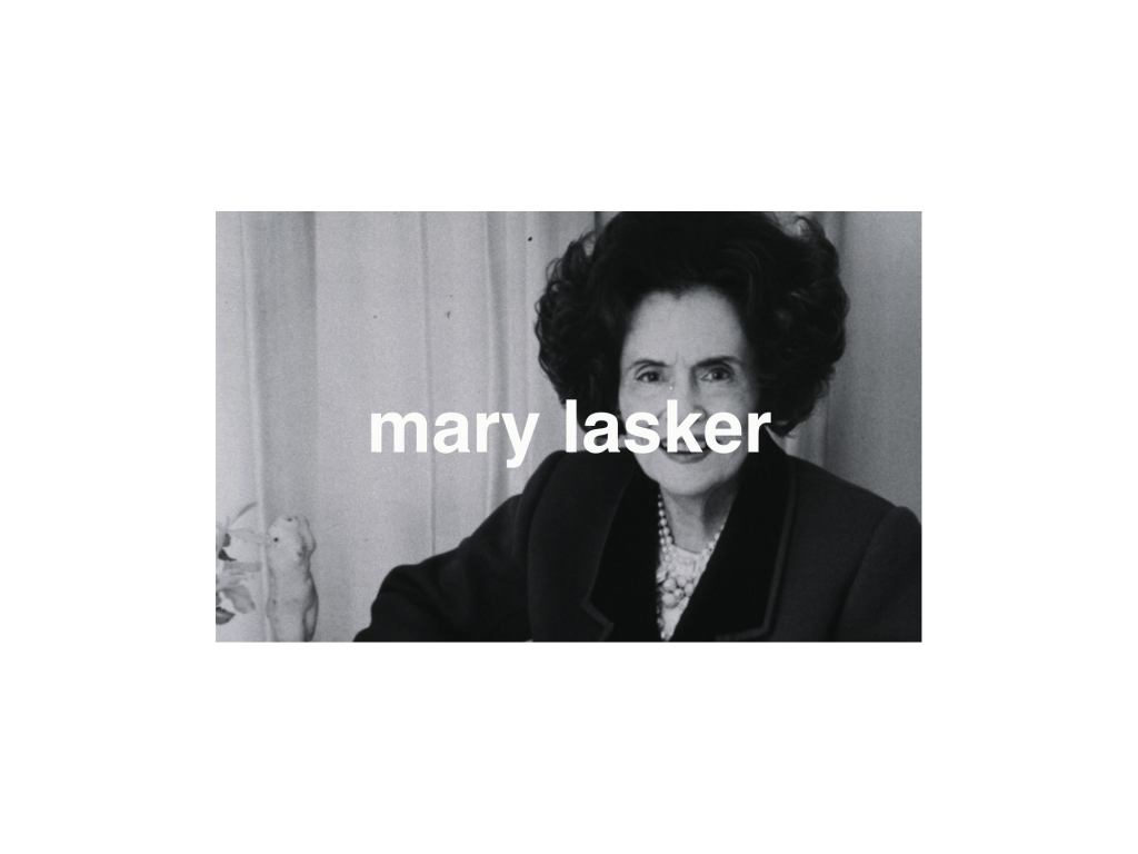 A black and white photo of a woman with big hair.